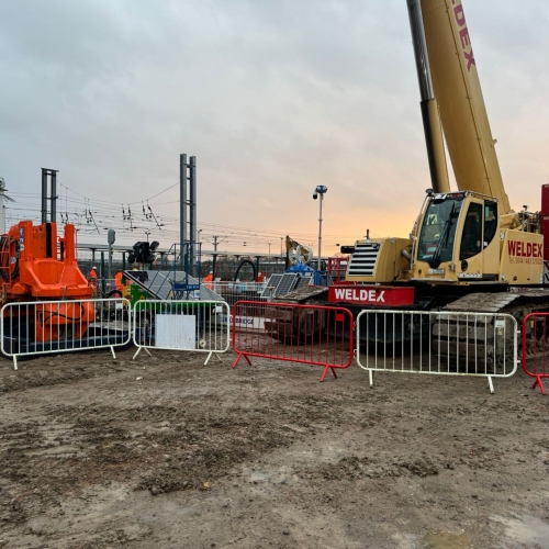 Piling rig by a railway line at dusk