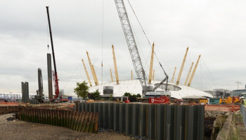 piling work on a construction site with O2 arena in the background