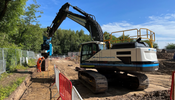 A movax driving piles into an embankment 